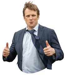 Bjorn Baker giving a thumbs-up, wearing a suit with a loosened tie.